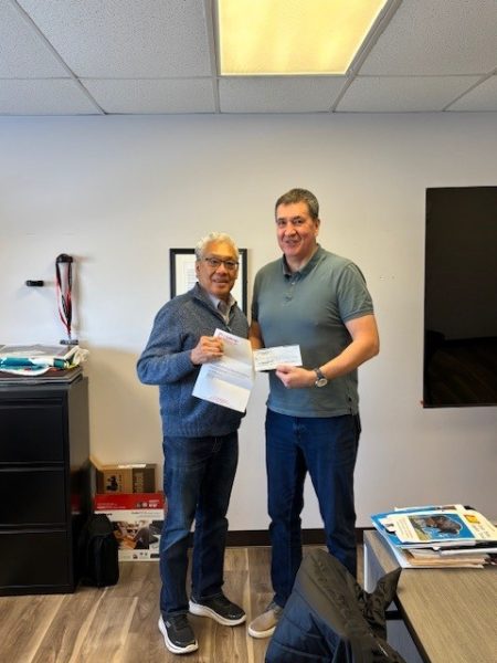 Mike Wong, Owner of Challenge Industries, presents a 2026 scholarship donation  cheque to Rob Shotclose